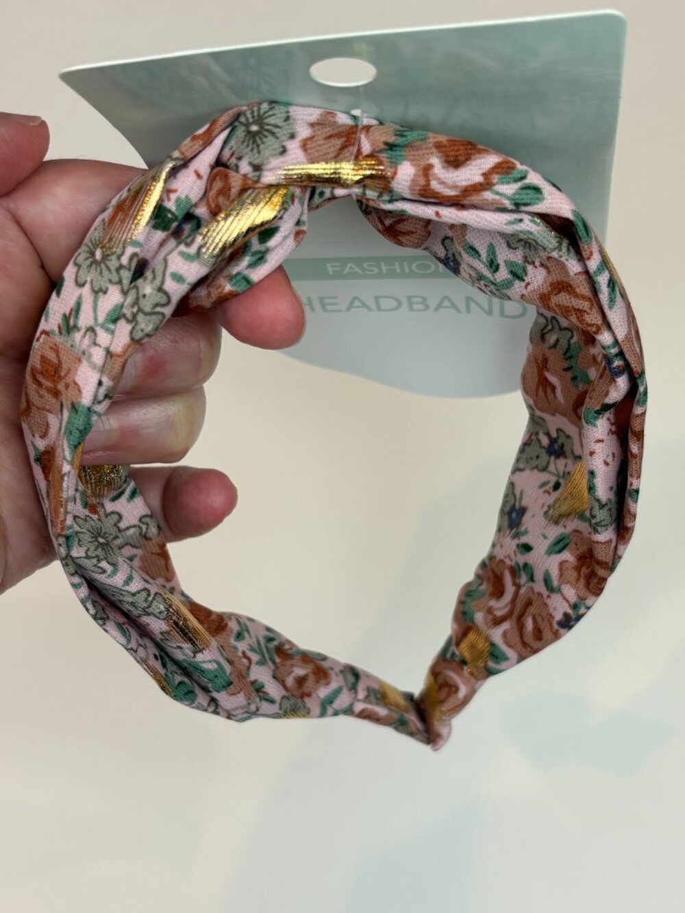 Cute pink floral twist-knot fashion headband featuring gold foil accent details